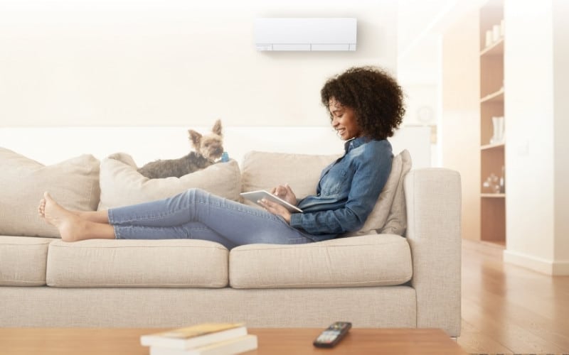 mitsubishi ductless above woman on couch
